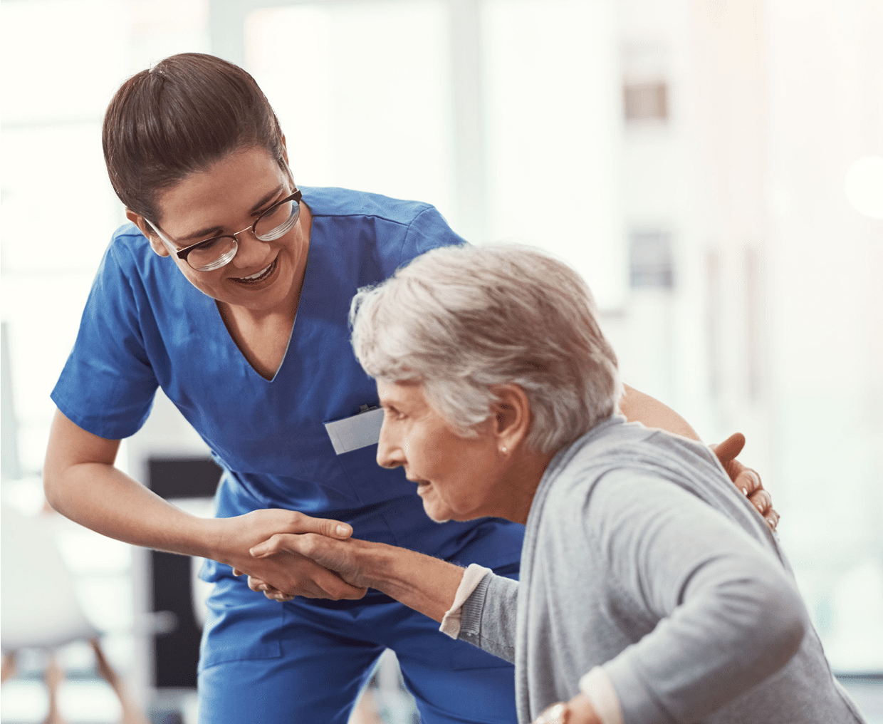 Caregiver supporting older patient with smile